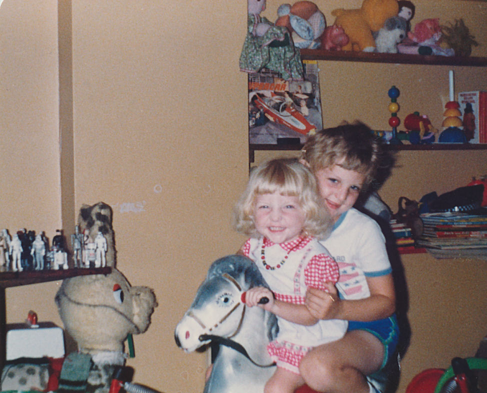 C.J. Carter-Stephenson on rocking horse with sister.